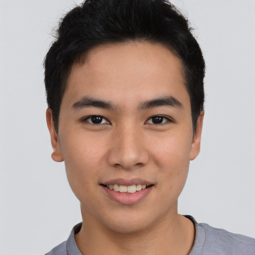 Joyful asian young-adult male with short  brown hair and brown eyes