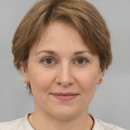 Joyful white adult female with medium  brown hair and brown eyes