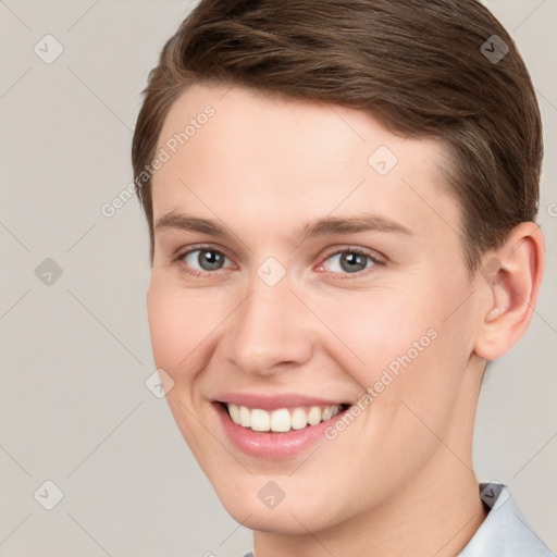 Joyful white young-adult female with short  brown hair and grey eyes