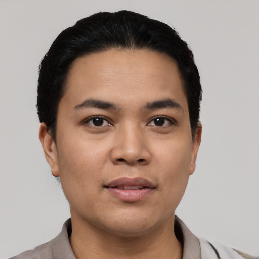 Joyful asian young-adult male with short  black hair and brown eyes