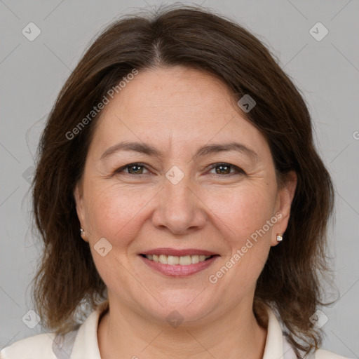 Joyful white adult female with medium  brown hair and brown eyes