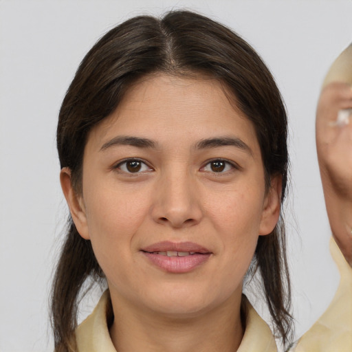 Joyful white young-adult female with medium  brown hair and brown eyes