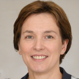 Joyful white adult female with medium  brown hair and grey eyes