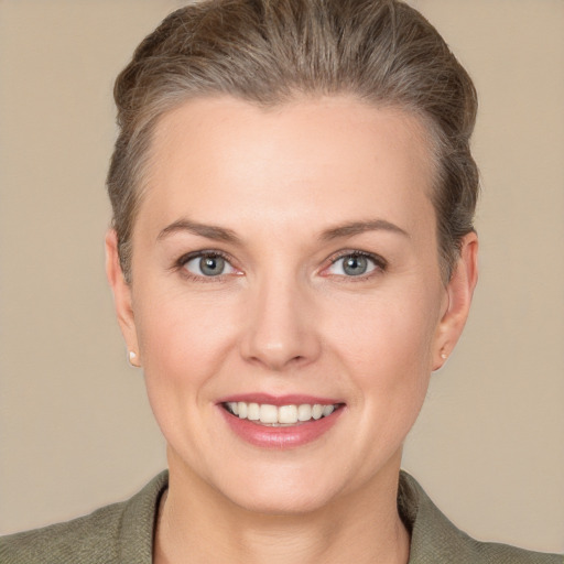 Joyful white young-adult female with short  brown hair and grey eyes