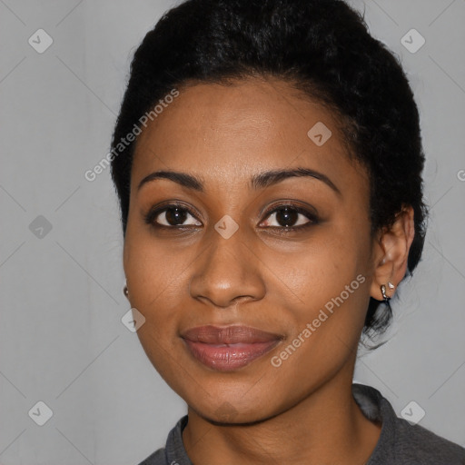 Joyful black young-adult female with short  black hair and brown eyes