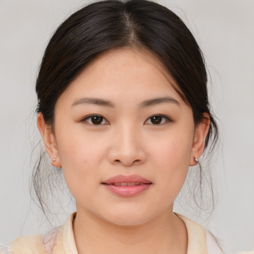 Joyful asian young-adult female with medium  brown hair and brown eyes