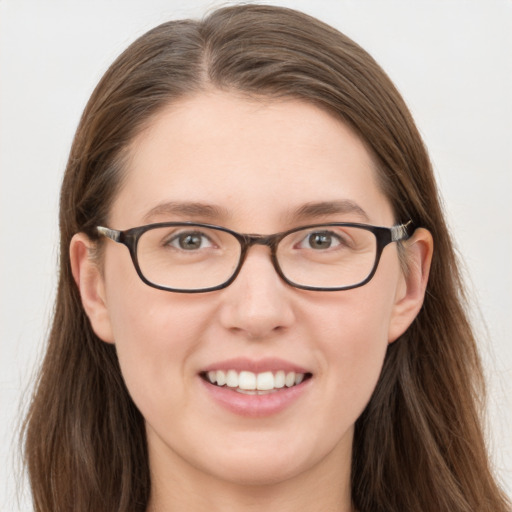 Joyful white young-adult female with long  brown hair and blue eyes