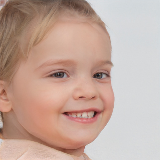 Joyful white child female with short  brown hair and blue eyes