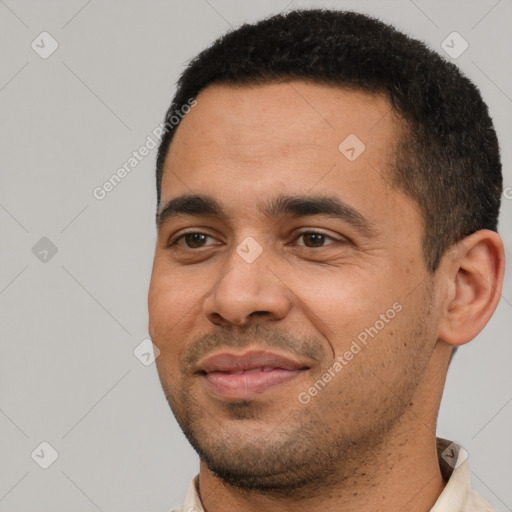 Joyful latino young-adult male with short  black hair and brown eyes