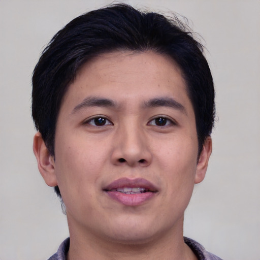 Joyful asian young-adult male with short  brown hair and brown eyes