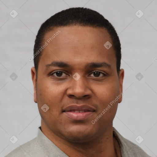 Joyful black young-adult male with short  brown hair and brown eyes