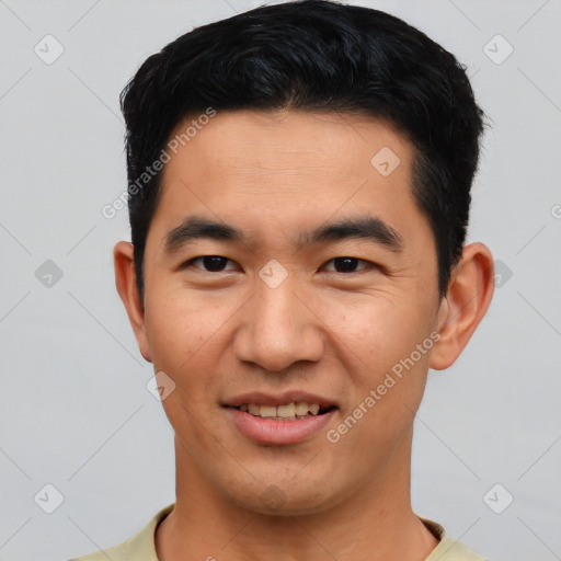 Joyful asian young-adult male with short  black hair and brown eyes