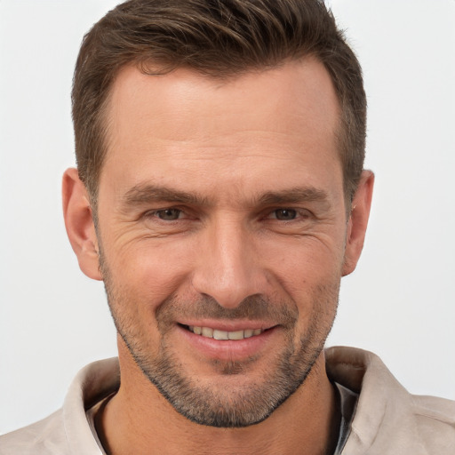 Joyful white adult male with short  brown hair and brown eyes