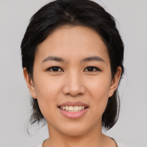 Joyful asian young-adult female with medium  black hair and brown eyes
