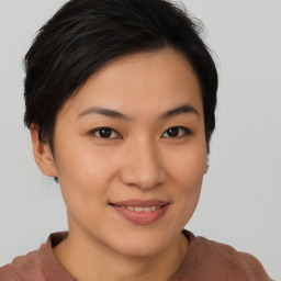 Joyful asian young-adult female with short  brown hair and brown eyes