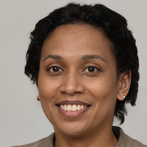Joyful latino adult female with short  brown hair and brown eyes