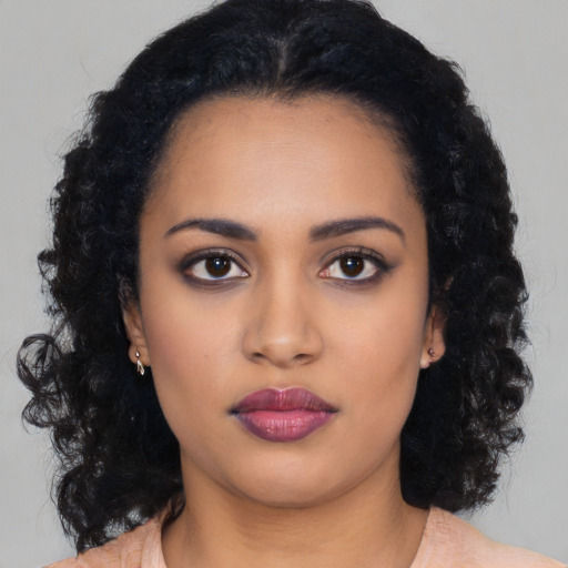 Neutral latino young-adult female with long  black hair and brown eyes