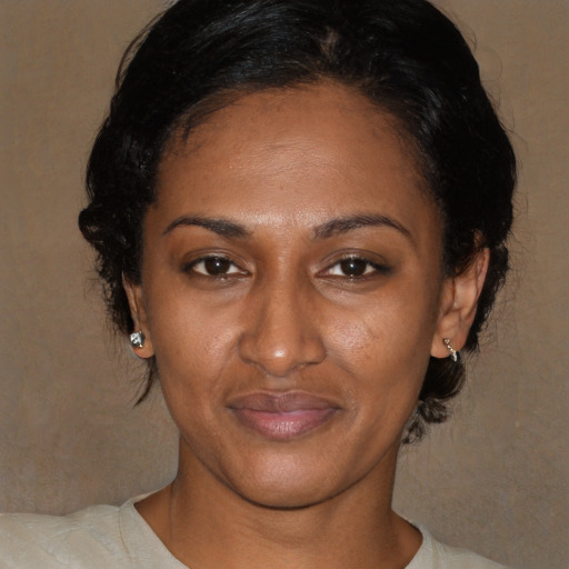 Joyful black young-adult female with medium  brown hair and brown eyes
