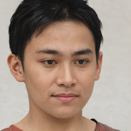 Joyful asian young-adult male with short  brown hair and brown eyes