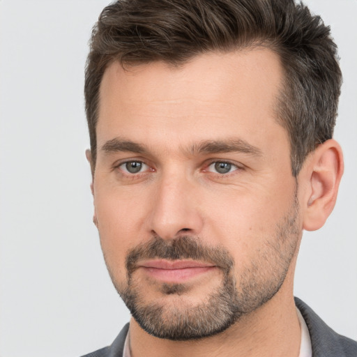 Joyful white adult male with short  brown hair and brown eyes