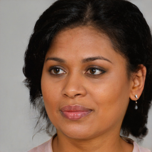 Joyful black young-adult female with medium  brown hair and brown eyes