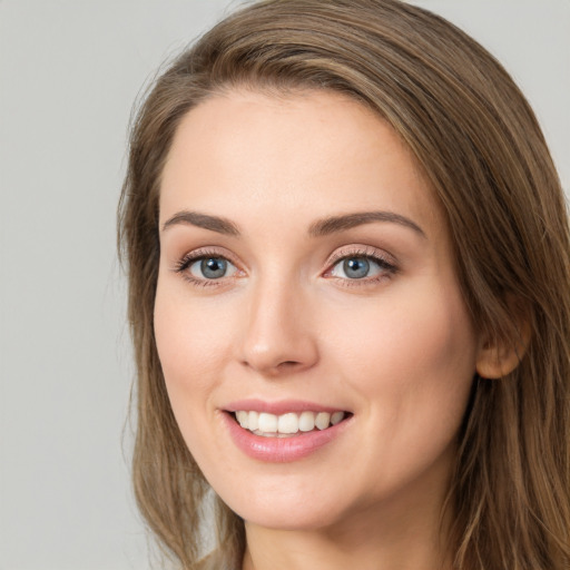 Joyful white young-adult female with long  brown hair and green eyes