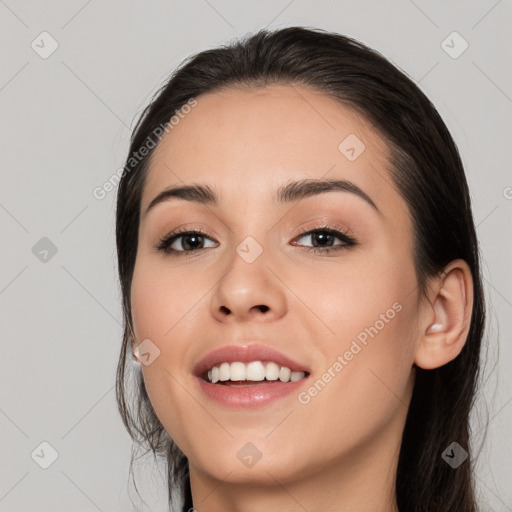 Joyful white young-adult female with long  black hair and brown eyes