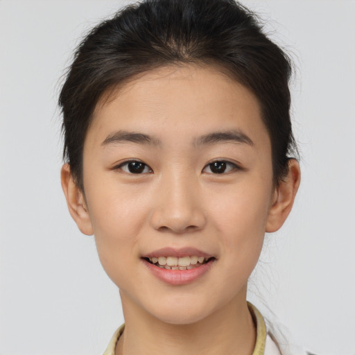 Joyful asian young-adult female with short  brown hair and brown eyes