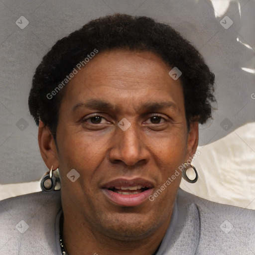 Joyful black adult male with short  brown hair and brown eyes