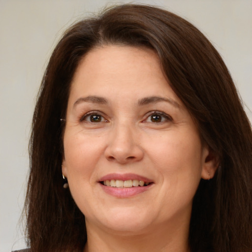 Joyful white adult female with medium  brown hair and brown eyes