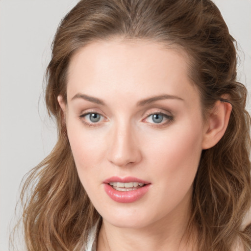 Joyful white young-adult female with long  brown hair and grey eyes