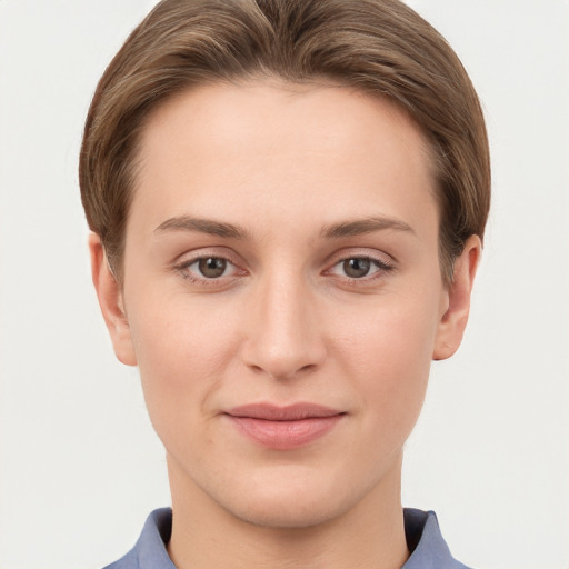 Joyful white young-adult female with short  brown hair and grey eyes