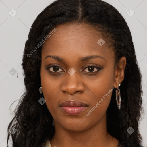 Joyful black young-adult female with long  brown hair and brown eyes