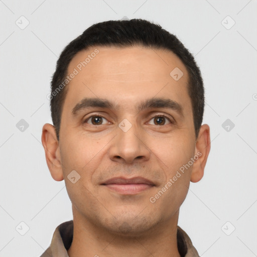 Joyful latino young-adult male with short  brown hair and brown eyes