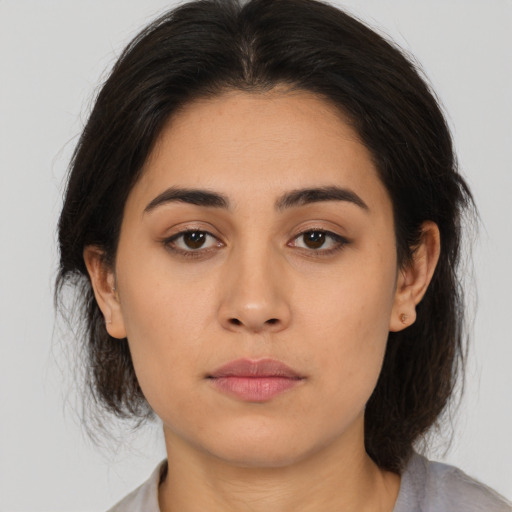 Neutral latino young-adult female with medium  brown hair and brown eyes