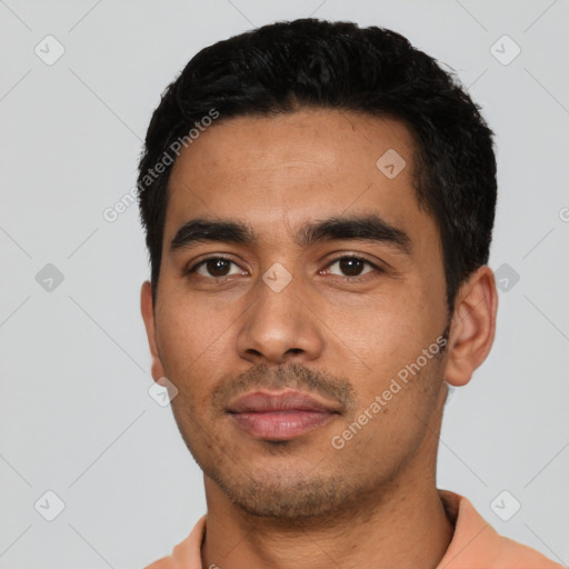 Neutral latino young-adult male with short  black hair and brown eyes