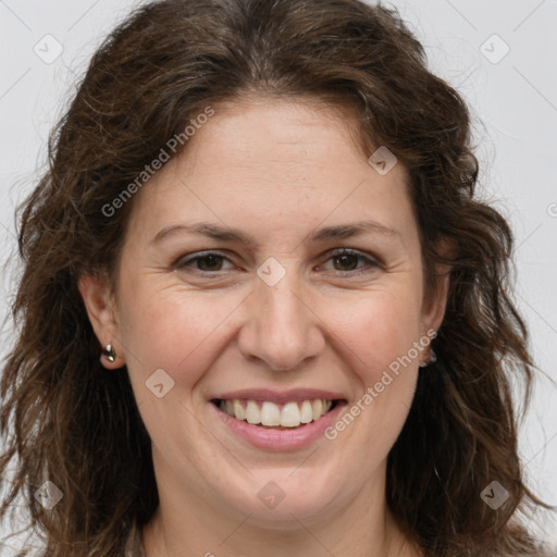 Joyful white adult female with long  brown hair and brown eyes