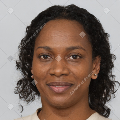 Joyful black adult female with medium  brown hair and brown eyes