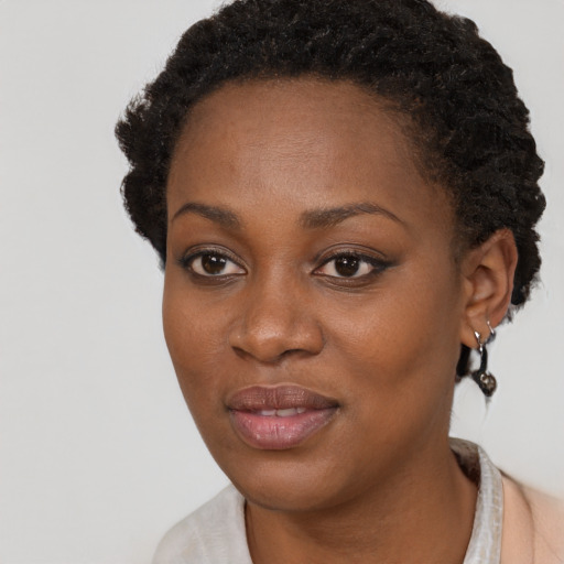 Joyful black young-adult female with short  brown hair and brown eyes