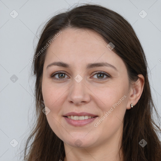 Joyful white young-adult female with long  brown hair and grey eyes