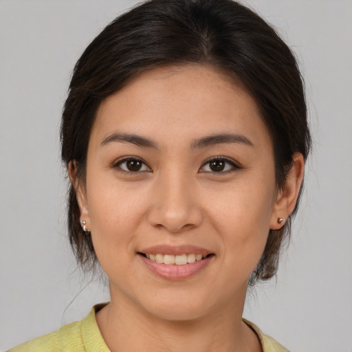 Joyful white young-adult female with medium  brown hair and brown eyes