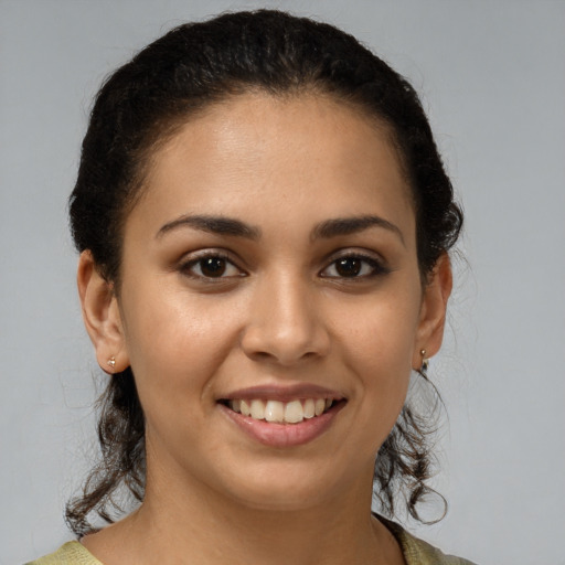 Joyful latino young-adult female with medium  brown hair and brown eyes