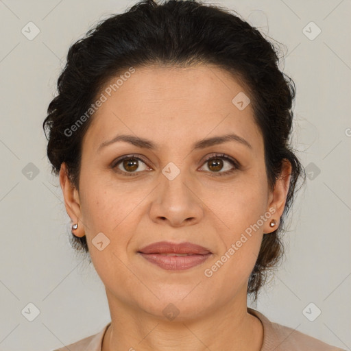 Joyful latino adult female with medium  brown hair and brown eyes