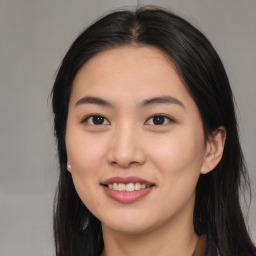 Joyful asian young-adult female with long  brown hair and brown eyes