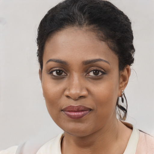 Joyful black young-adult female with short  brown hair and brown eyes