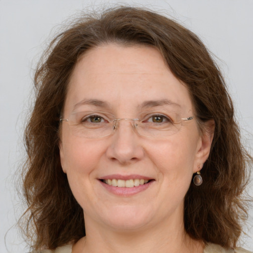 Joyful white adult female with medium  brown hair and grey eyes