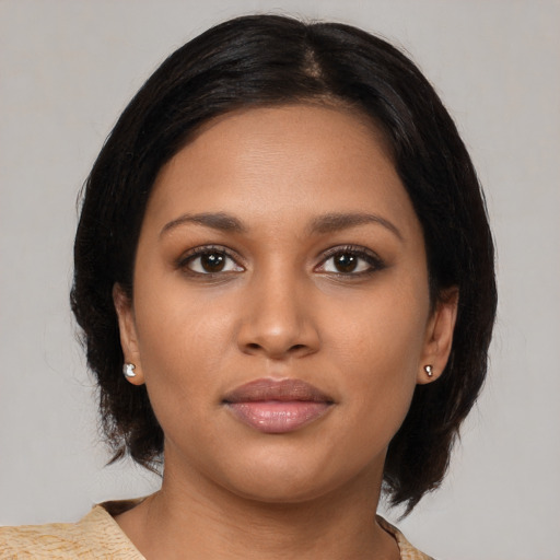 Joyful black young-adult female with medium  brown hair and brown eyes