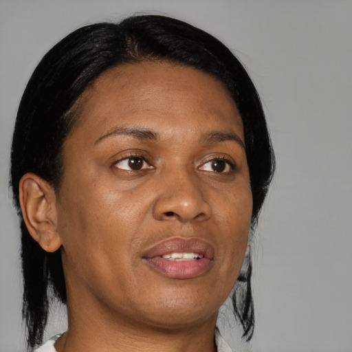 Joyful black adult female with medium  brown hair and brown eyes