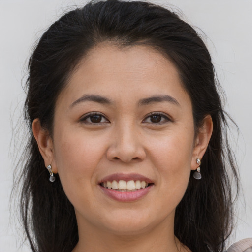 Joyful white young-adult female with long  brown hair and brown eyes