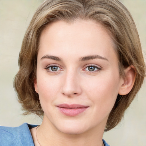 Joyful white young-adult female with medium  brown hair and blue eyes